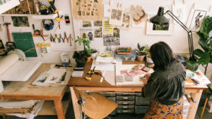 A woman sitting at a desk in front of papers.